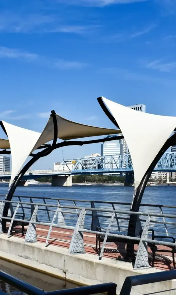 Southbank Riverwalk shade sails along the St. Johns River with the Jacksonville skyline behind