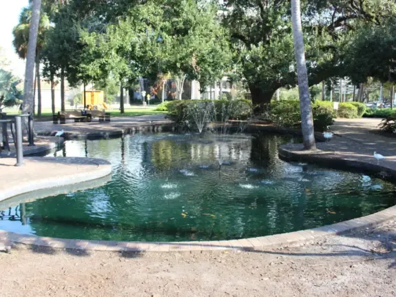 Small fountain under live oaks at Lake Eola Park in Orlando, FL, near downtown businesses