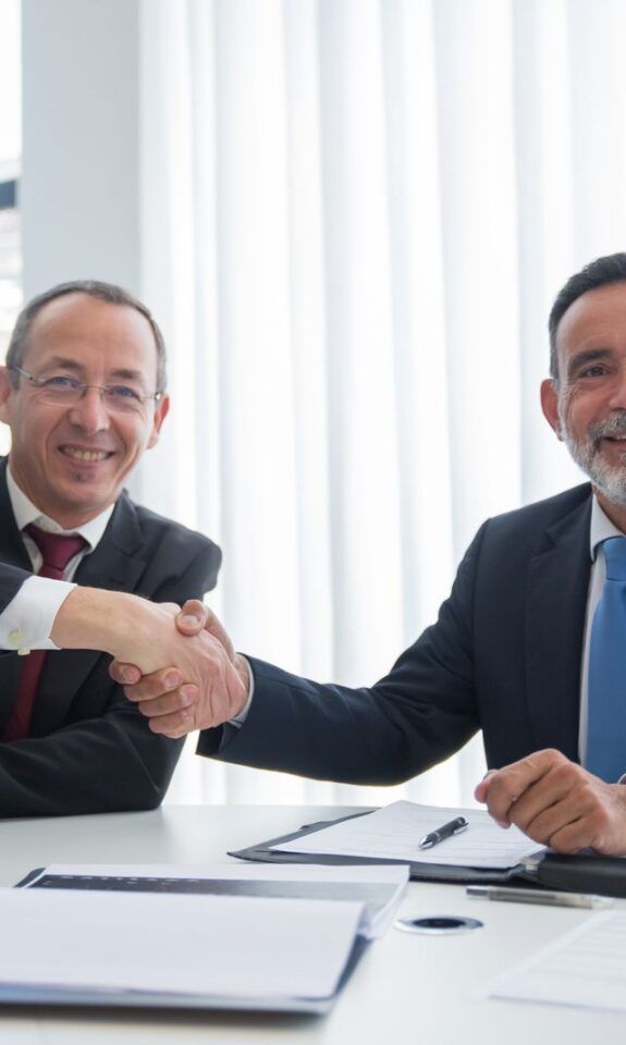 Business partners shaking hands to close a deal