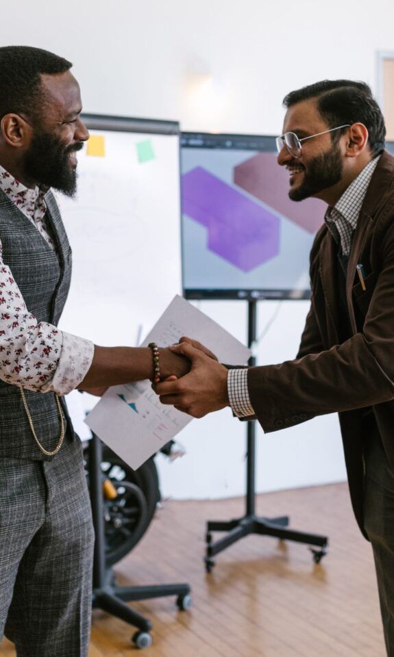 Business professionals shaking hands in an office