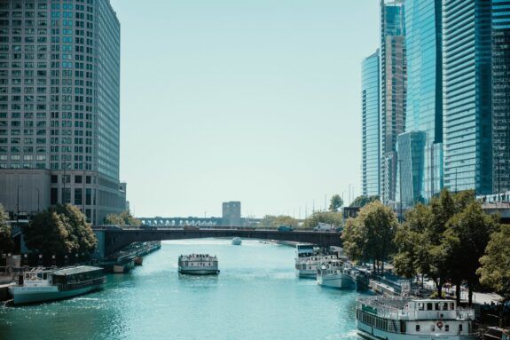 Chicago River surrounded by skyscrapers on a sunny day