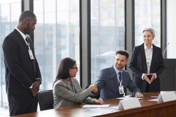 Group of professionals shaking hands during a business meeting