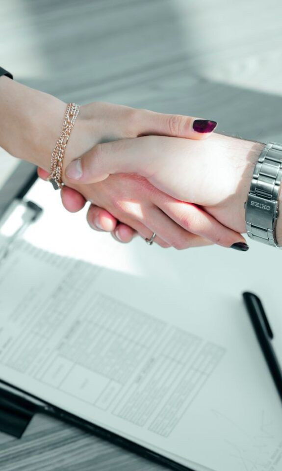 Two professionals shaking hands on a deal