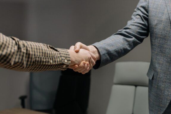 Colleagues shaking hands in an office