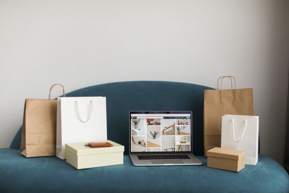 Laptop with shopping bags and boxes representing an online store