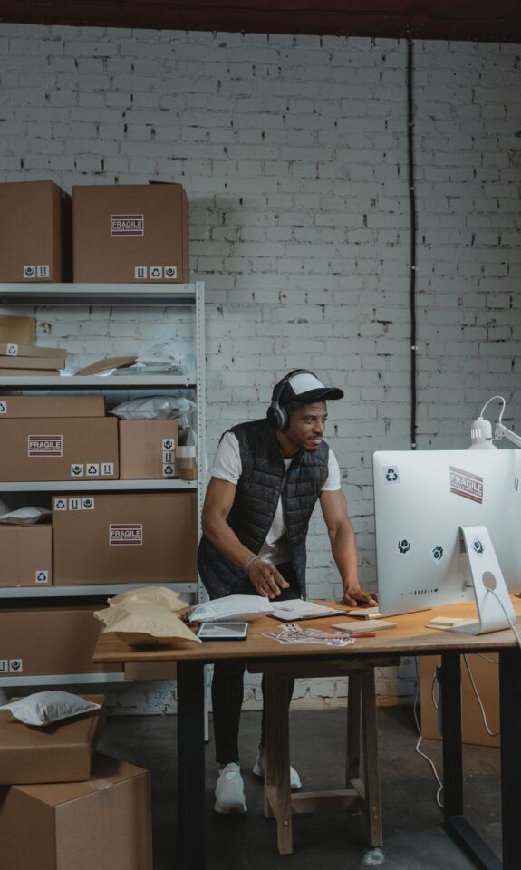 Warehouse worker packing ecommerce orders for fulfillment