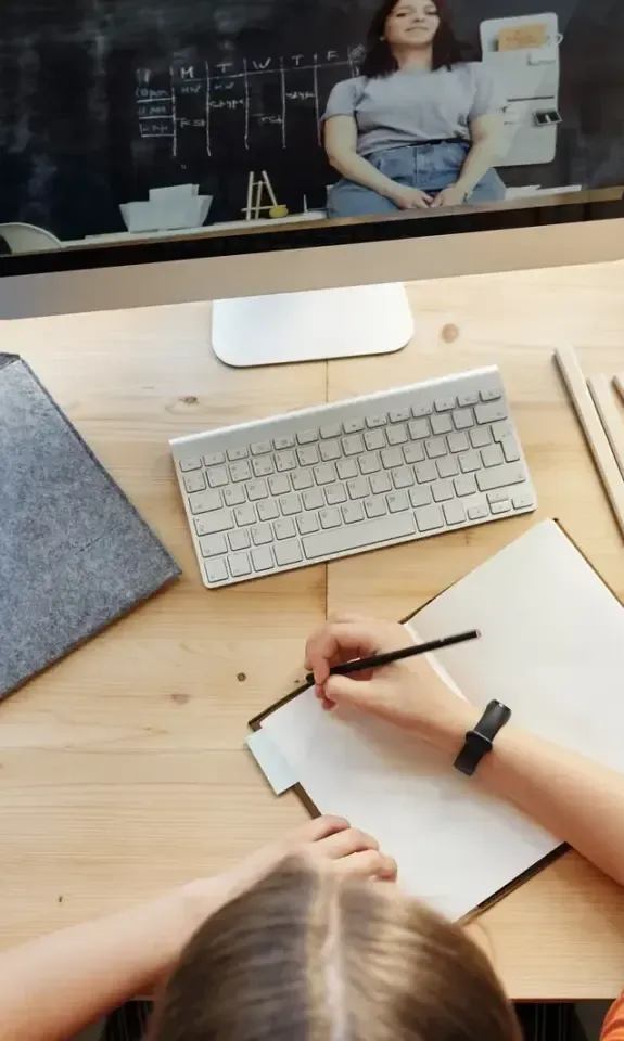 Top view of a content workspace with a desktop computer, tablet and notebook