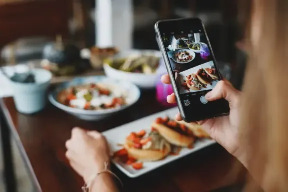 Food creator photographing dishes on a smartphone for recipe content