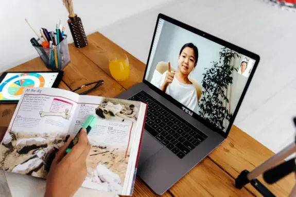 Instructor teaching a live online lesson shown on a laptop screen