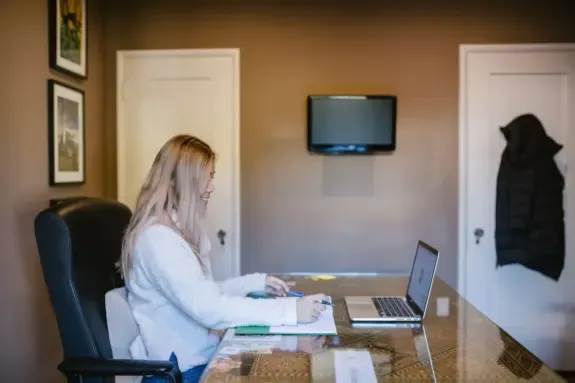 Owner of a remote internet business working at a home office desk