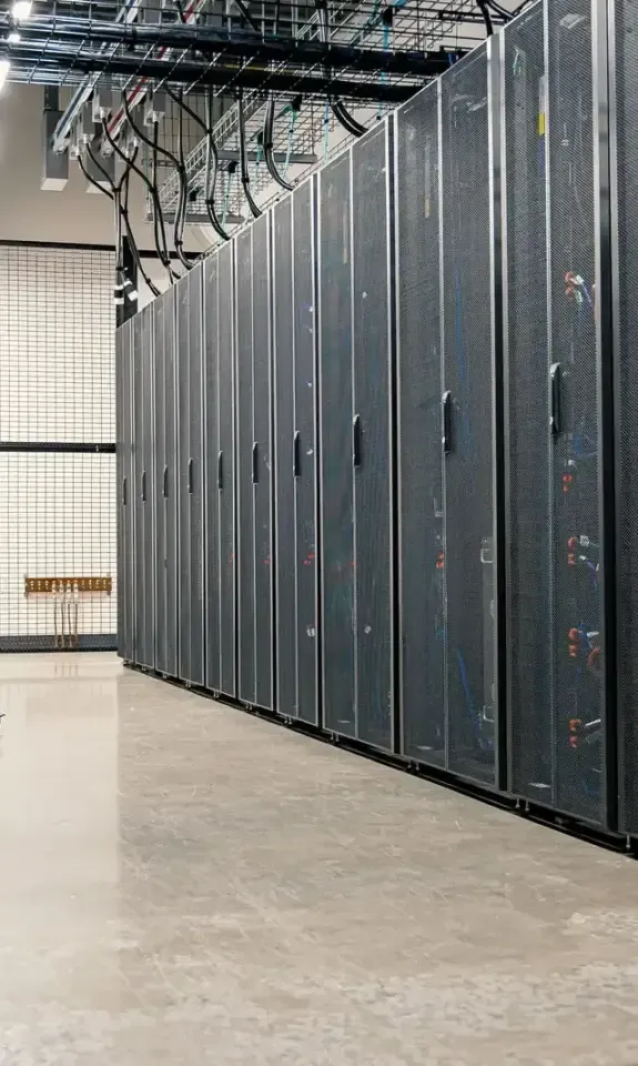 Aisle between server cabinets in a data center with a monitoring workstation